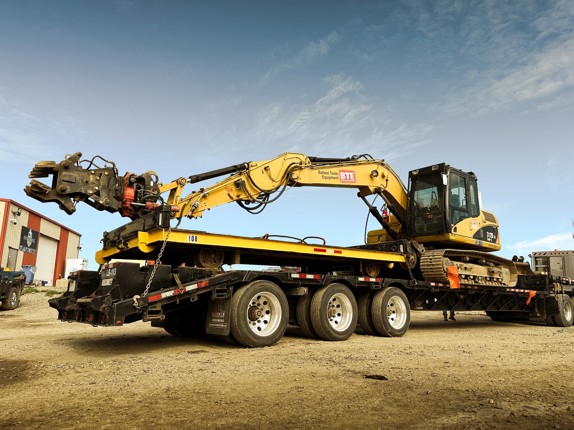 Hi-rail excavator loaded for transport