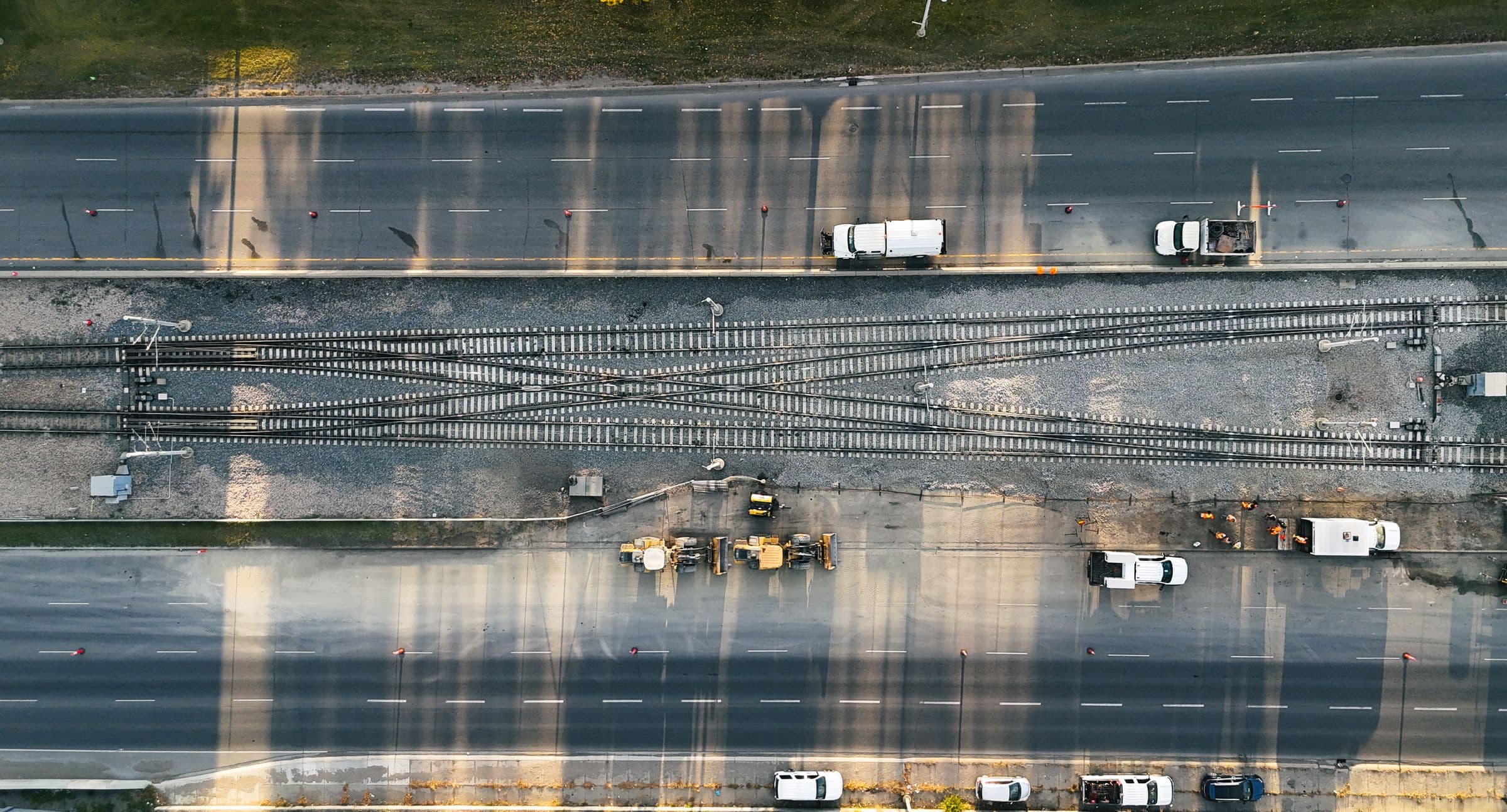 Aerial view of crews replacing an LRT crossing between traffic lanes in Calgary