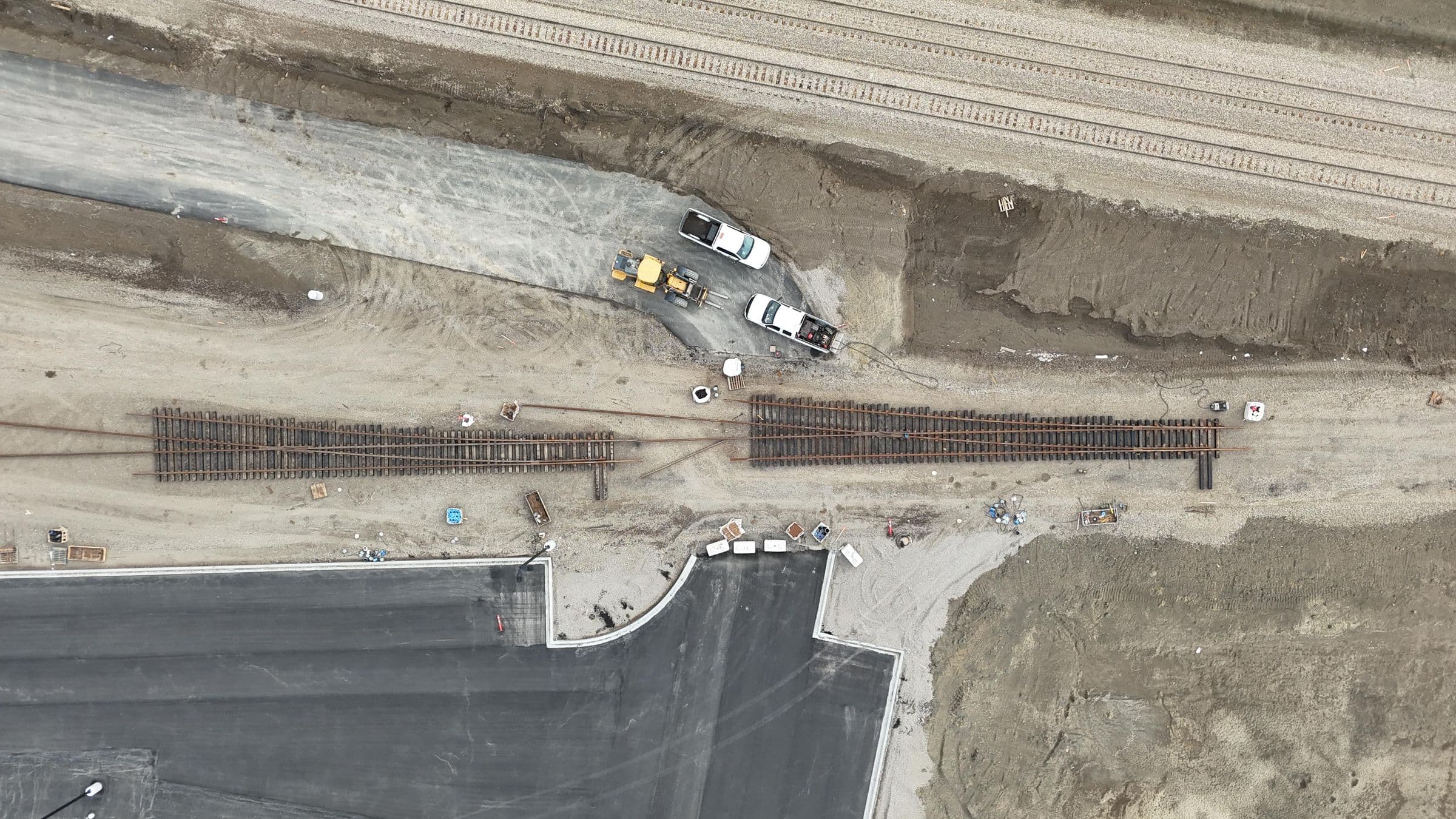 Aerial view of track panels staged beside a new industrial spur alignment