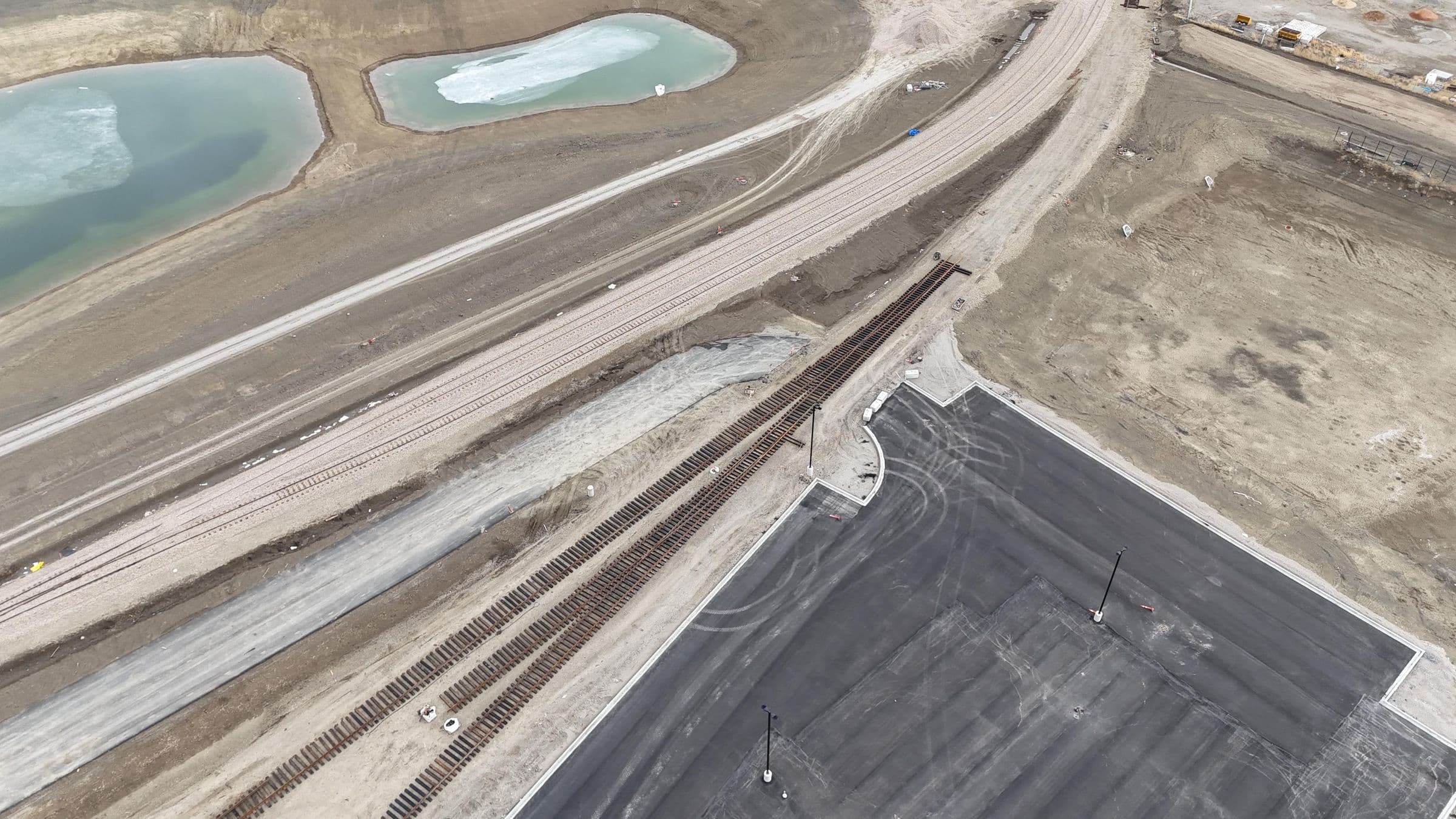 Aerial view of a new industrial rail spur curving toward a facility