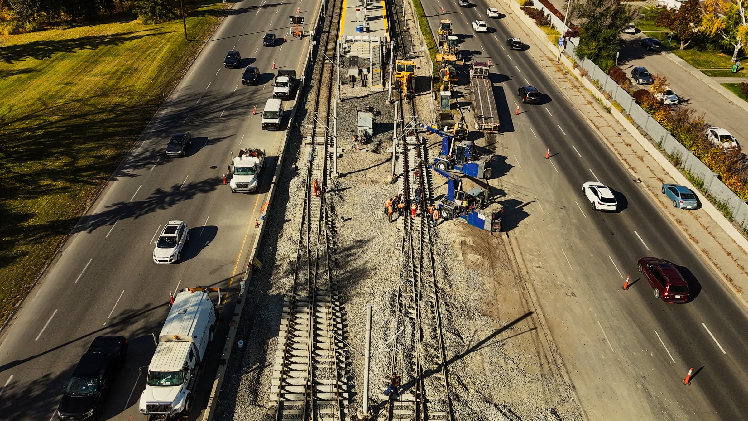 Aerial view of a rail construction site beside live traffic