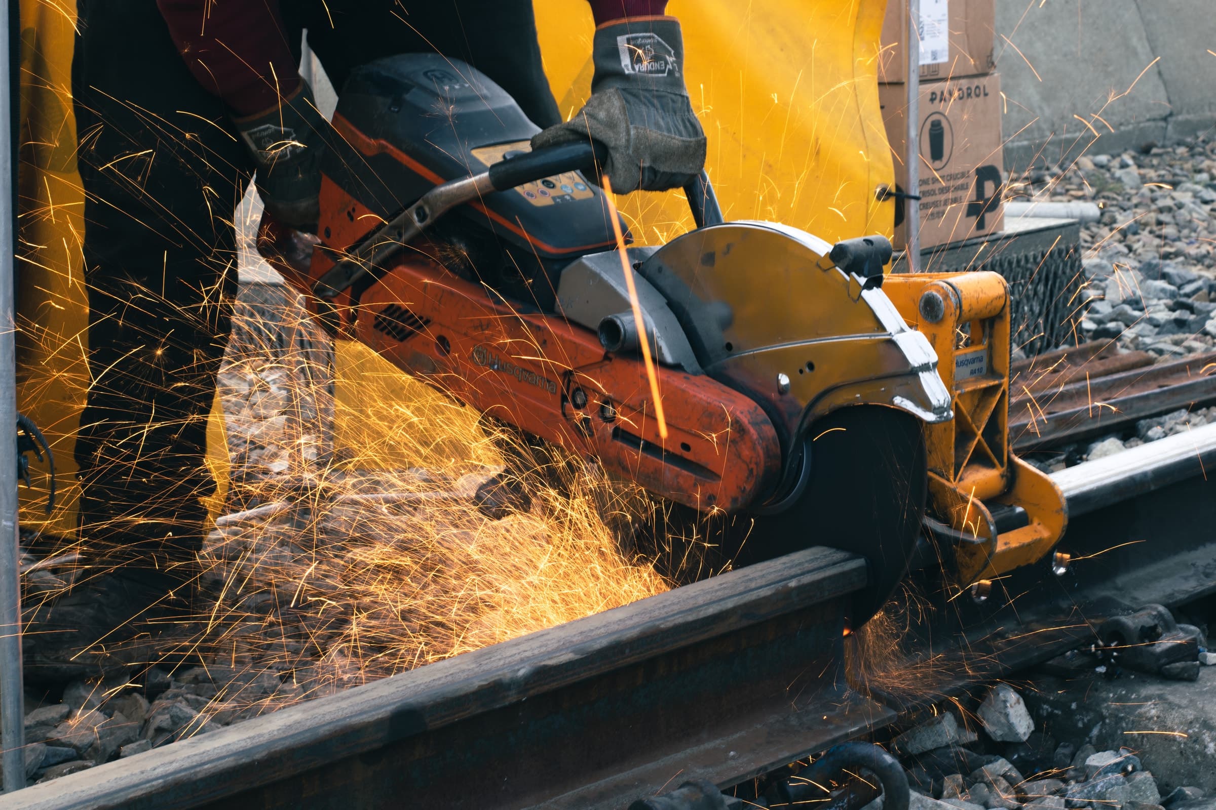Operator cutting rail with a rail-mounted saw